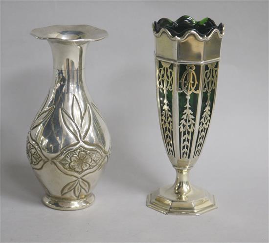 An Edwardian pierced silver spill vase, Goldsmiths & Silversmiths Co Ltd, London, 1909, 15.7cm & one other vase.